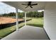 View of a covered patio with ceiling fan, columns, and view of yard at 250 Bluejay St, Clayton, NC 27520