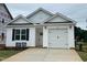 Charming new construction home with a white exterior, garage, and landscaped front yard at 250 Bluejay St, Clayton, NC 27520