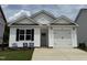 New construction with white siding, black accents, and a one-car garage at 250 Bluejay St, Clayton, NC 27520