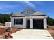New construction with white siding, black shutters, and an attached garage, all under a bright blue sky at 250 Bluejay St, Clayton, NC 27520