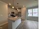 Bright kitchen features granite countertops, stainless steel appliances, and a center island at 250 Bluejay St, Clayton, NC 27520