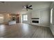 Open-concept space with a living room featuring a fireplace, and a kitchen with island at 250 Bluejay St, Clayton, NC 27520