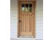 Elegant wooden front door with glass accents, adding a touch of sophistication and natural light to the entryway at 2654 Lawndale, Durham, NC 27705