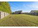 Spacious backyard featuring lush green grass, bordered by a privacy fence at 28 Lee Woods Dr, Clayton, NC 27520