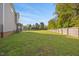 Picture of a huge grassy backyard area, partially bordered by a wooden fence at 28 Lee Woods Dr, Clayton, NC 27520