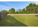 Grassy backyard featuring a designated fire pit and privacy fencing at 28 Lee Woods Dr, Clayton, NC 27520