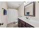 Well-lit bathroom with a large mirror, white sink, and shower/tub combination at 28 Lee Woods Dr, Clayton, NC 27520