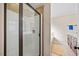 Bathroom featuring glass shower, tan tiled walls, and neutral colored cabinets and countertops at 28 Lee Woods Dr, Clayton, NC 27520