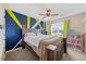Cozy bedroom with a ceiling fan, large bed, and a bright accent wall with a side window at 28 Lee Woods Dr, Clayton, NC 27520