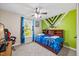 Bedroom features a ceiling fan, and green and beige walls, with a double bed and gray carpet at 28 Lee Woods Dr, Clayton, NC 27520