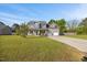 Inviting two-story home with an attached two-car garage, landscaping, and a large front lawn at 28 Lee Woods Dr, Clayton, NC 27520