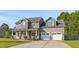 Two-story home featuring a covered front porch and attached two-car garage at 28 Lee Woods Dr, Clayton, NC 27520