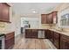 An open kitchen with stainless steel appliances, granite countertops, and wood-style flooring at 28 Lee Woods Dr, Clayton, NC 27520