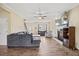 Comfortable living room with a fireplace, ceiling fan, and staircase at 28 Lee Woods Dr, Clayton, NC 27520