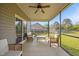 Relaxing screened-in patio with ceiling fan and outdoor seating area at 28 Lee Woods Dr, Clayton, NC 27520