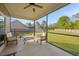 Covered screened-in patio with outdoor furniture and a view of the backyard at 28 Lee Woods Dr, Clayton, NC 27520