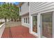 A wooden deck with access to the house and a view of the green, tree filled yard at 2804 Brenfield Dr, Raleigh, NC 27606