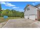 Back of house with a concrete patio, three car garage, basketball goal, and storage shed at 2804 Brenfield Dr, Raleigh, NC 27606