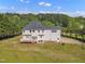 Spacious backyard featuring a wooden deck, lush green lawn, and mature trees at 2804 Brenfield Dr, Raleigh, NC 27606