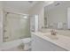 A well-lit bathroom featuring a shower with glass doors, a mirrored vanity, and tile flooring at 2804 Brenfield Dr, Raleigh, NC 27606