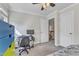 Functional bedroom with a desk setup, featuring modern storage and ample natural lighting from the windows at 2804 Brenfield Dr, Raleigh, NC 27606