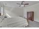 Bright bedroom with neutral carpet, ceiling fan, and dark wood dresser, offering a warm atmosphere at 2804 Brenfield Dr, Raleigh, NC 27606
