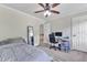A comfortable bedroom features a ceiling fan, a mirror, plush carpeting, and a dedicated workspace at 2804 Brenfield Dr, Raleigh, NC 27606