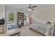 Inviting bedroom with neutral walls, plush carpet, a ceiling fan, and two windows for natural light at 2804 Brenfield Dr, Raleigh, NC 27606