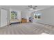 Large bonus room with neutral carpet, ceiling fan, big windows, and flexible living space at 2804 Brenfield Dr, Raleigh, NC 27606