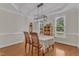 Well-lit dining room with hardwood floors, elegant decor, and large windows at 2804 Brenfield Dr, Raleigh, NC 27606