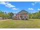 Beautiful two-story brick home with a well-manicured lawn and mature trees at 2804 Brenfield Dr, Raleigh, NC 27606