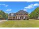 Charming two-story brick home with a manicured lawn and lush greenery at 2804 Brenfield Dr, Raleigh, NC 27606