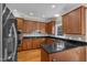 Modern kitchen showcasing stainless steel appliances, granite countertops, and ample cherry wood cabinet space at 2804 Brenfield Dr, Raleigh, NC 27606