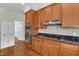 Modern kitchen featuring granite countertops, cherry wood cabinets, and stainless steel appliances at 2804 Brenfield Dr, Raleigh, NC 27606