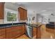 An inviting kitchen featuring wood cabinets, granite countertops, a window over sink, and stainless steel appliances at 2804 Brenfield Dr, Raleigh, NC 27606