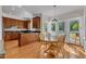 An eat-in kitchen features light wood cabinets, granite countertops, stainless steel appliances, and backyard access at 2804 Brenfield Dr, Raleigh, NC 27606