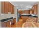 Well-equipped kitchen featuring granite countertops, stainless steel appliances, and cherry wood cabinetry for culinary adventures at 2804 Brenfield Dr, Raleigh, NC 27606
