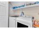 Convenient laundry room with modern washer and dryer, shelving for storage, and good lighting at 2804 Brenfield Dr, Raleigh, NC 27606