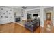Cozy living room with fireplace, custom shelving, and leather sofa, seamlessly blends comfort and style at 2804 Brenfield Dr, Raleigh, NC 27606