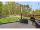 A backyard with a playhouse, grass, wooden fence and outdoor seating area at 3011 Ginger Hill Ln, Durham, NC 27703