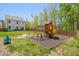Spacious backyard with a playset, patio, and fenced yard at 3011 Ginger Hill Ln, Durham, NC 27703