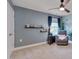 Cozy bedroom with a ceiling fan, reading chair, and custom wall mural at 3011 Ginger Hill Ln, Durham, NC 27703