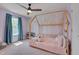 Playful bedroom with purple walls, canopy bed, and lots of natural light at 3011 Ginger Hill Ln, Durham, NC 27703
