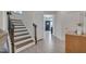 Welcoming foyer featuring staircase with dark wood treads and luxury vinyl flooring at 3011 Ginger Hill Ln, Durham, NC 27703