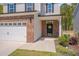 Close-up view of a home's entryway, showcasing a brick facade and welcoming front door at 3011 Ginger Hill Ln, Durham, NC 27703