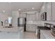 Well-lit kitchen featuring gray cabinets, granite countertops, and stainless steel appliances at 3011 Ginger Hill Ln, Durham, NC 27703