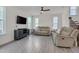 Bright living room with neutral couches, a ceiling fan, and gray wood floors at 3011 Ginger Hill Ln, Durham, NC 27703