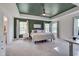 Spacious main bedroom featuring a tray ceiling, ceiling fan, and lots of natural light at 3011 Ginger Hill Ln, Durham, NC 27703
