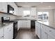 Modern kitchen with granite counters, white cabinetry, and stainless appliances at 302 Shiloh Way, Mebane, NC 27302