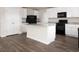 Spacious kitchen with stainless steel appliances, granite counters, white cabinets, and an island at 302 Shiloh Way, Mebane, NC 27302